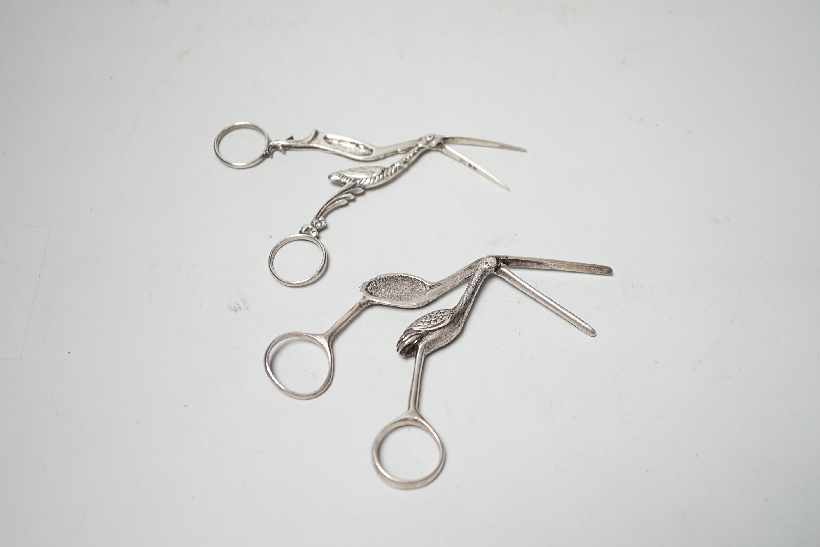 A pair of novelty late Victorian silver sugar nips, modelled as a stork, Rosenthal, Jacob & Co, London, 1888, 10.6cm and a similar Irish pair, John Smythe, Dublin, 1898.